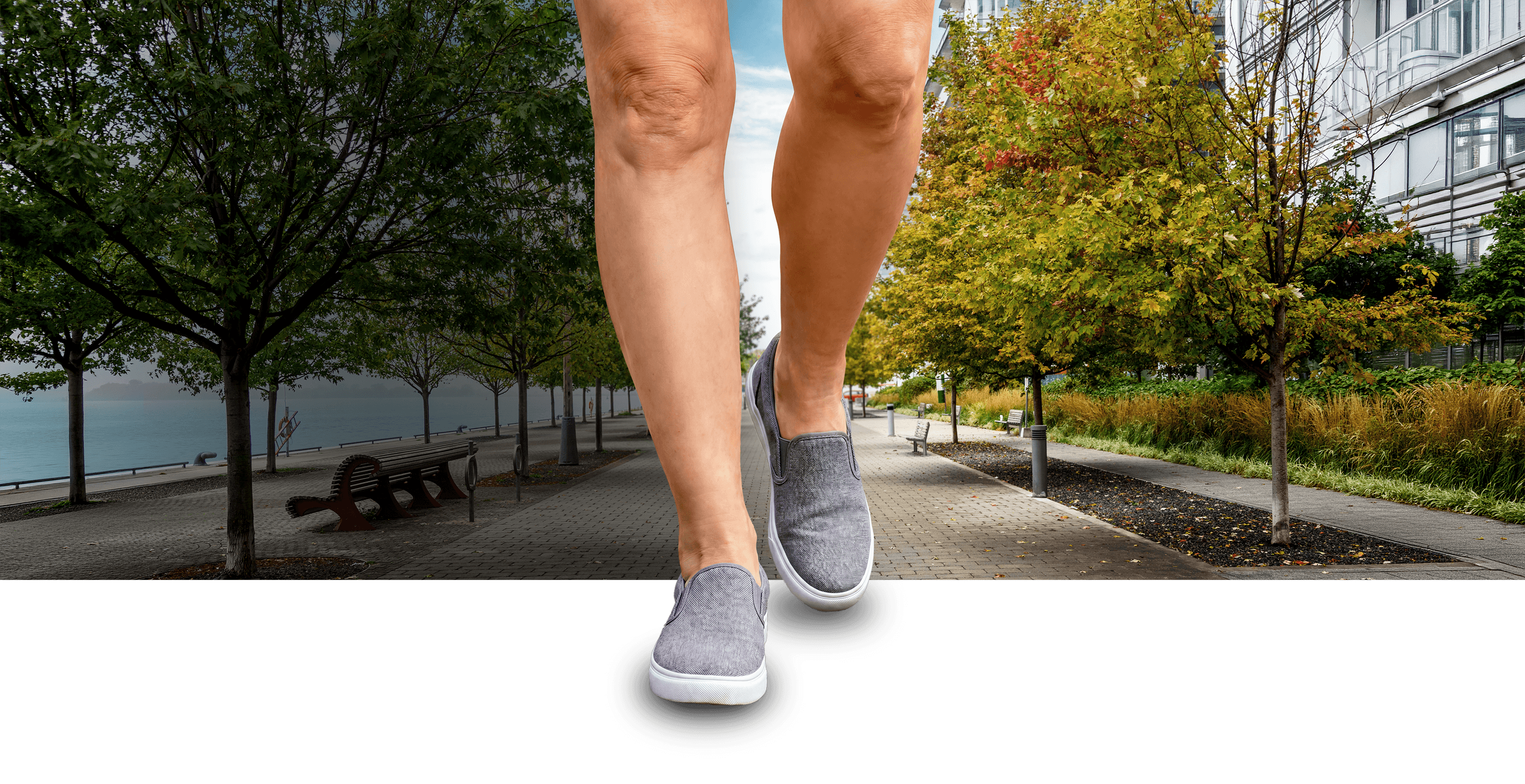 A disproportionately large pair of legs, visible from mid-thigh down, walking down a sidewalk.